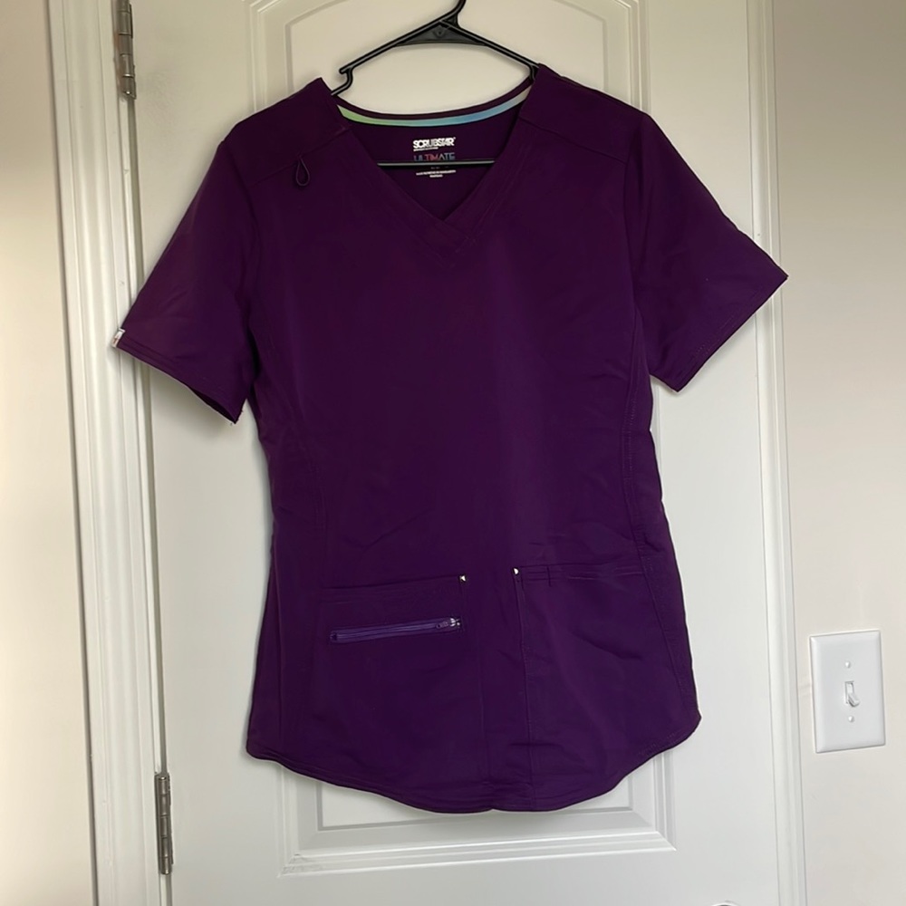 Small, dark purple scrub set with 8 pockets total and cuffed ankles.
